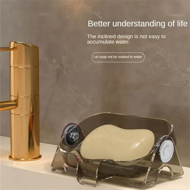 Soap dish with soap bar next to a gold faucet on a marble background