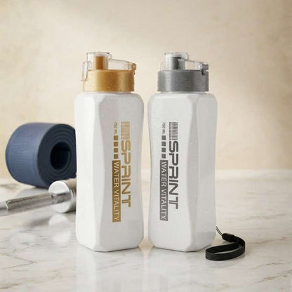 Two white water bottles with gold and black accents on a marble surface.
