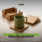Bamboo square 6-coaster set with holder on a wooden surface, featuring a green mug.