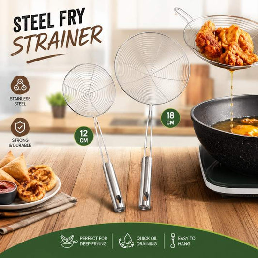 Two stainless steel fry strainers on a wooden surface with fried food and a pot in the background.
