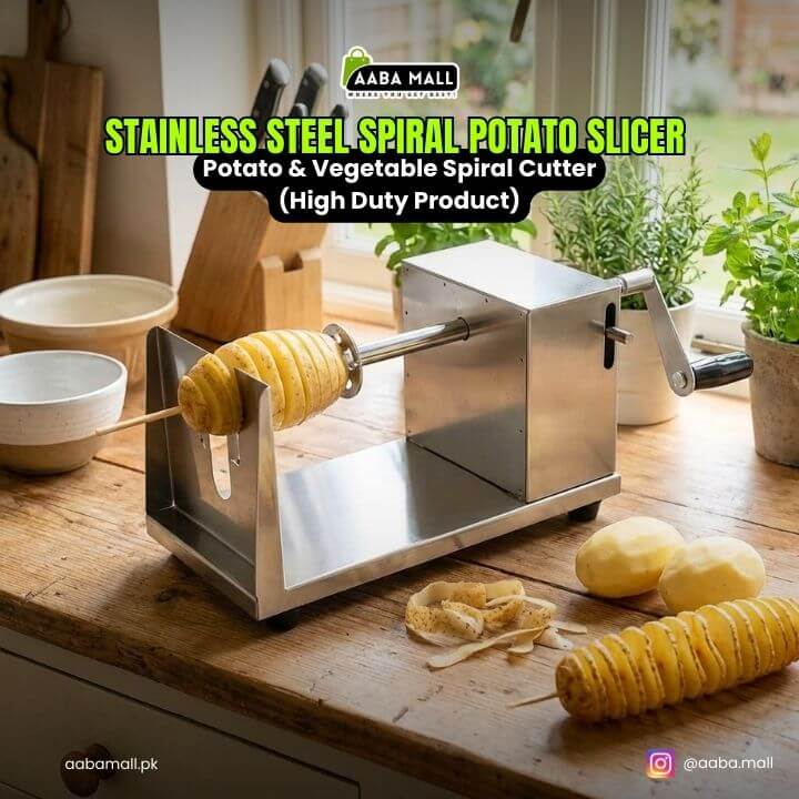 Stainless steel spiral potato slicer on a kitchen counter with potatoes and plant decor.