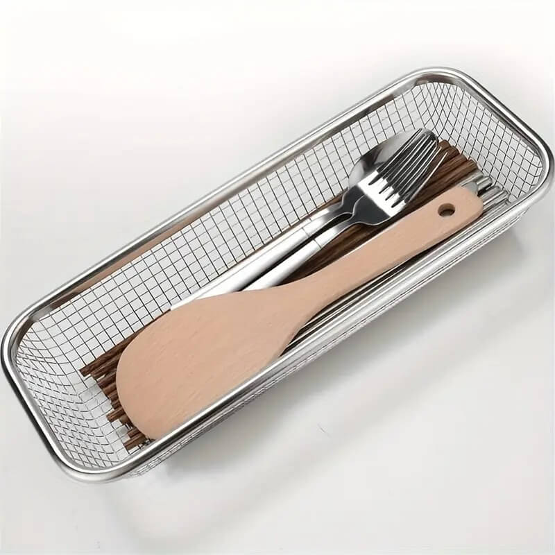 Metal mesh tray with wooden spoon, fork, and spatula on a white background