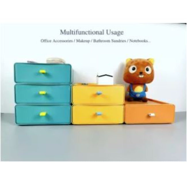 Set of clear stackable plastic drawer organizer boxes, one filled with makeup products and another with jewelry, shown neatly stored on a vanity desk.