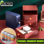 Set of clear stackable plastic drawer organizer boxes, one filled with makeup products and another with jewelry, shown neatly stored on a vanity desk.