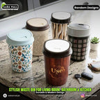 Set of stylish waste bins with various designs on a marble surface.
