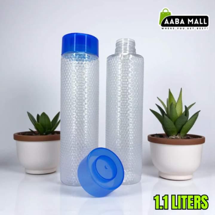 Two water bottles with blue lids on a white surface with potted plants in the background, branded with Aaba Mall.