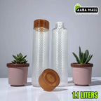 Two glass bottles with wooden lids and small potted plants on a white surface, with 'Aaba Mall' branding.