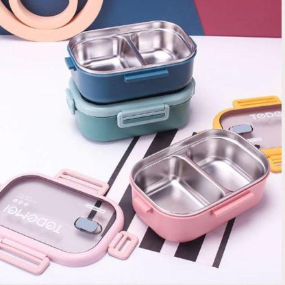 Set of stainless steel lunch boxes in various colors on a striped background