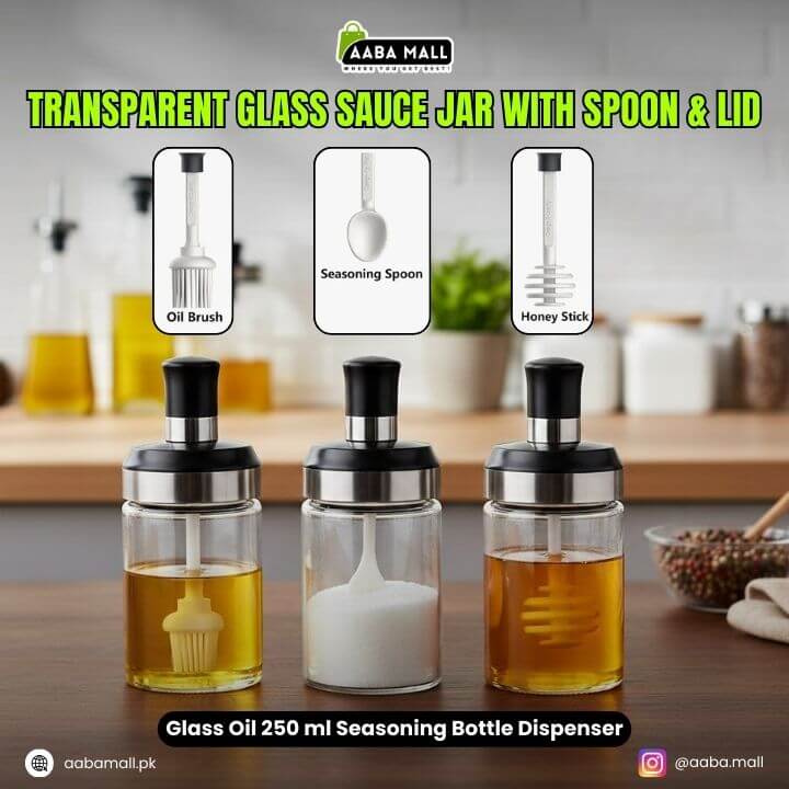 Transparent glass sauce jar with spoon and lid on a kitchen counter, featuring oil brush, seasoning spoon, and honey stick attachments.