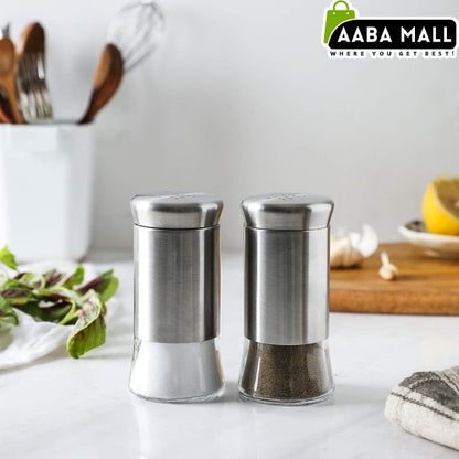 Two stainless steel salt and pepper shakers on a kitchen counter with Aaba Mall branding.