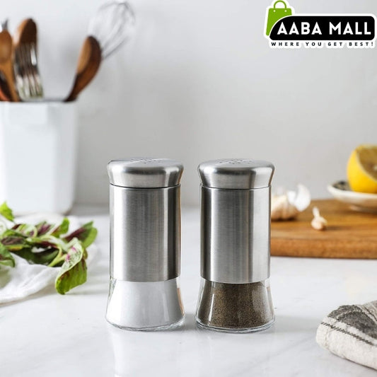 Two stainless steel salt and pepper shakers on a kitchen counter with Aaba Mall branding.