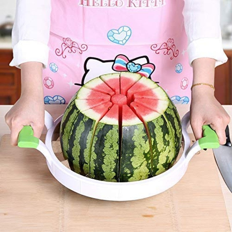 Person cutting a watermelon with a Hello Kitty-themed apron on a wooden table.