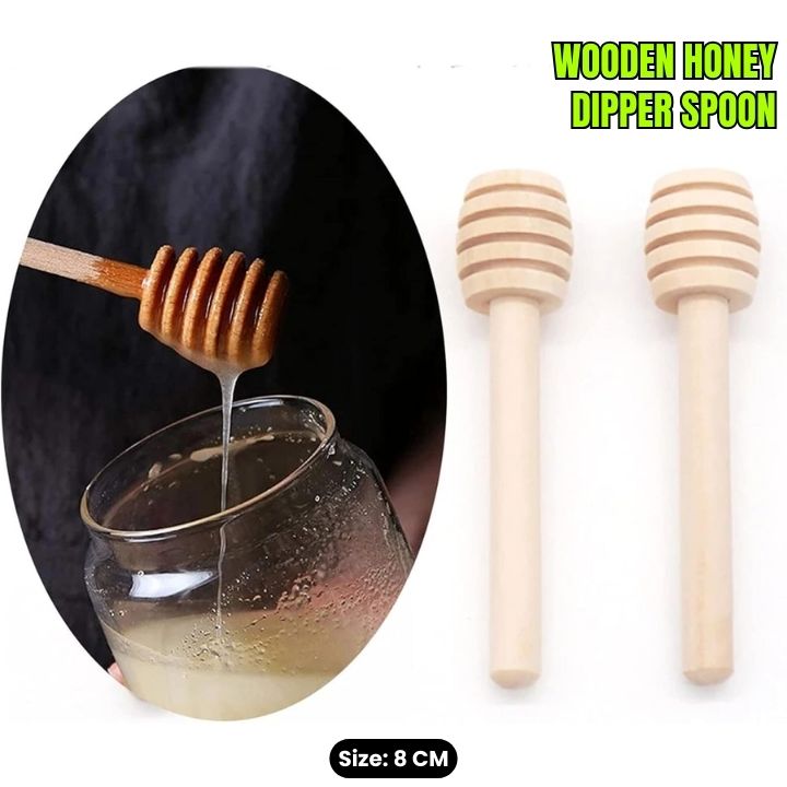 Wooden honey dipper spoon being used to pour honey into a glass jar, with two additional spoons on a white background.