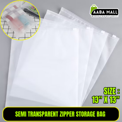 Close-up of a semi-transparent, thickened plastic zipper storage bag filled with folded sweaters, showing the smooth zipper and dustproof material in a closet.