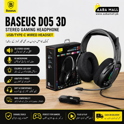 Baseus D05 3D Stereo Gaming Headset in black, shown alongside its retail packaging box and a small adapter on a wooden surface. The image features promotional text in English and Urdu, a 'Baseus' brand logo, and an 'AABA MALL' store logo in the top corners.