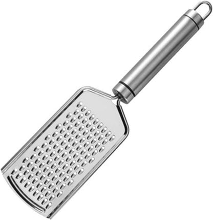 Close-up of a stainless steel handheld cheese grater/zester with razor-sharp micro-blades, shown zesting the bright yellow peel of a lemon on a cutting board.