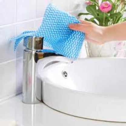 Person cleaning a sink with a blue cloth