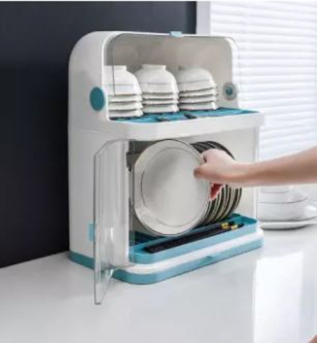 Covered plastic dish drying rack and storage cabinet with plates bowls and cutlery on kitchen countertop