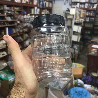 Cubic plastic storage container held in hand to show its practical size 250gms