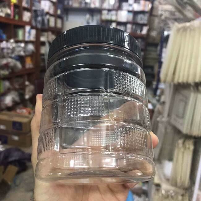 Cubic plastic storage jar with black airtight lid held in hand 500gms 