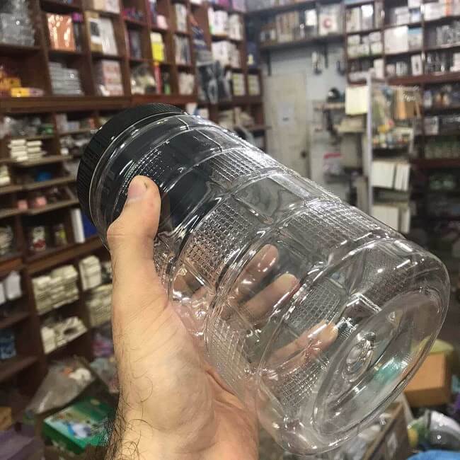 Cubic plastic storage container held in hand to show its practical size 1kg