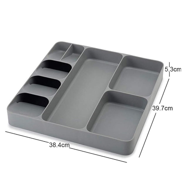 LARGE Grey plastic cutlery tray organizer shown placed inside a kitchen drawer, neatly separating a full set of silver spoons, knives, and forks in the dedicated compartments.