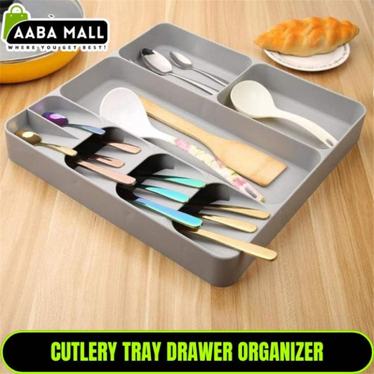 LARGE Grey plastic cutlery tray organizer shown placed inside a kitchen drawer, neatly separating a full set of silver spoons, knives, and forks in the dedicated compartments.
