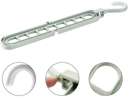 9-hole folding clothes hanger sorting rack shown vertically in a small closet to save space, white organizer