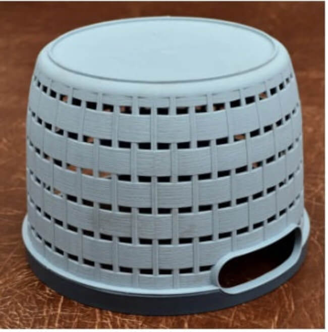 Gray woven stool on a brown surface
