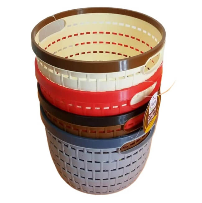 Stack of three woven baskets with visible brand label on a white background