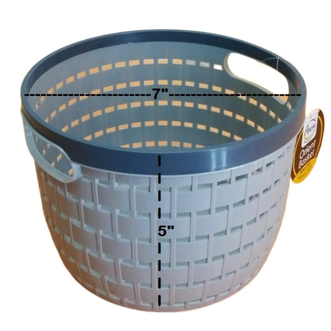 Black multipurpose wire storage basket filled with fresh red apples and oranges, sitting on a kitchen countertop, demonstrating air flow and fruit storage.