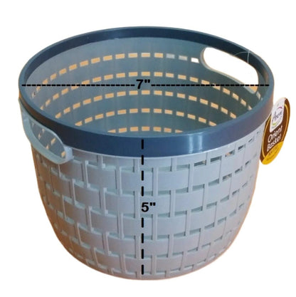 Black multipurpose wire storage basket filled with fresh red apples and oranges, sitting on a kitchen countertop, demonstrating air flow and fruit storage.