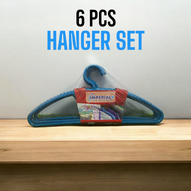 Set of 6 classic white plastic cloth hangers with swivel hooks hanging neatly in a closet, holding a mix of shirts and trousers.