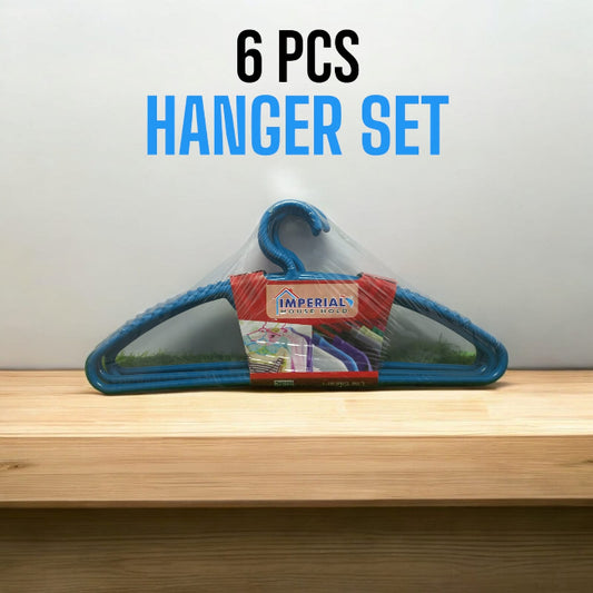 Set of 6 classic white plastic cloth hangers with swivel hooks hanging neatly in a closet, holding a mix of shirts and trousers.