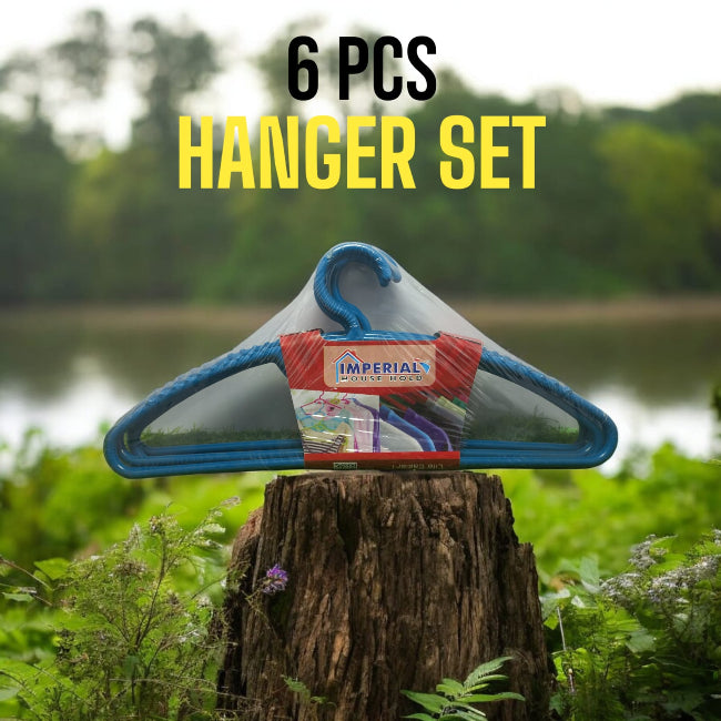 Set of 6 classic white plastic cloth hangers with swivel hooks hanging neatly in a closet, holding a mix of shirts and trousers.