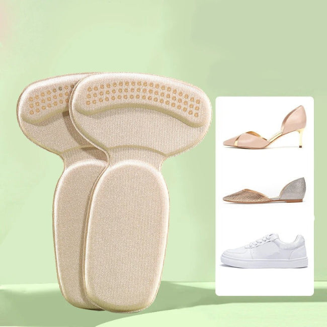 One pair of light grey adhesive memory foam heel cushion pads, shown being stuck into the back heel lining of a black shoe to demonstrate anti-wear protection and improved fit.