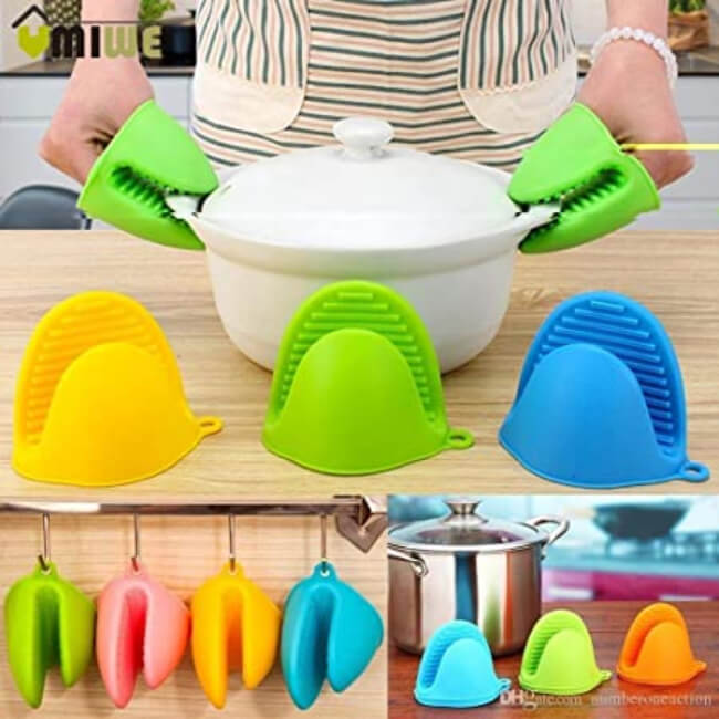 Colorful silicone pot holders on a kitchen counter with a pot in the background.
