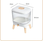 Large 12KG airtight plastic rice and grain storage box with a white lid and transparent body, shown sitting on a kitchen counter next to a scoop, filled with white rice.