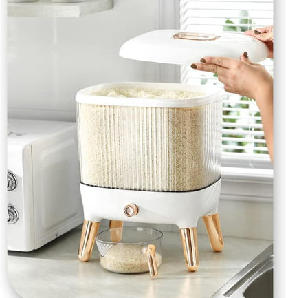 Large 12KG airtight plastic rice and grain storage box with a white lid and transparent body, shown sitting on a kitchen counter next to a scoop, filled with white rice.