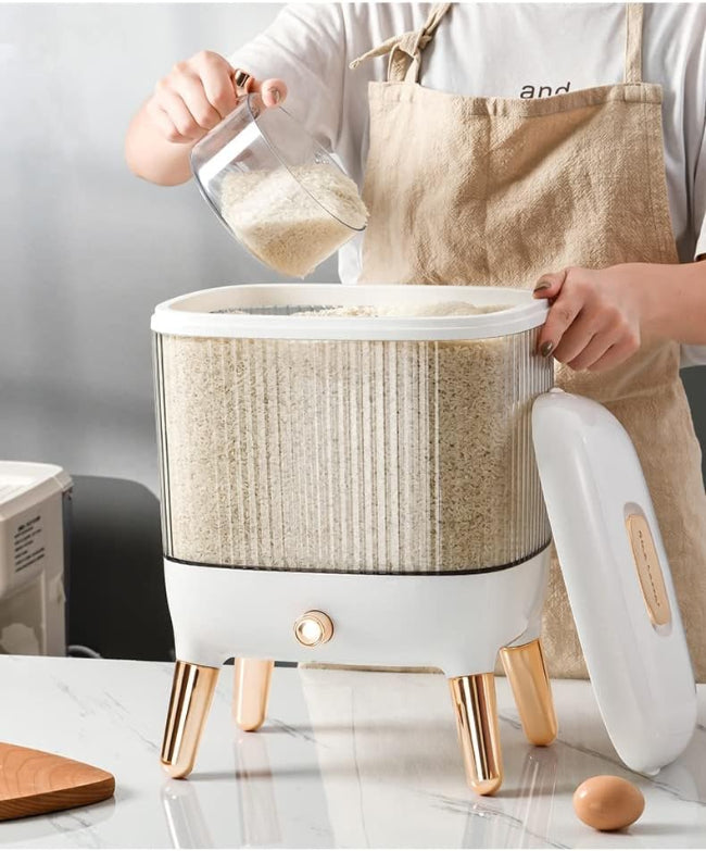 Large 12KG airtight plastic rice and grain storage box with a white lid and transparent body, shown sitting on a kitchen counter next to a scoop, filled with white rice.