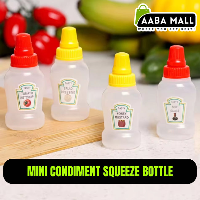 Set of two clear mini squeeze condiment bottles, one filled with red ketchup and one with white mayonnaise, next to a packed lunch box.