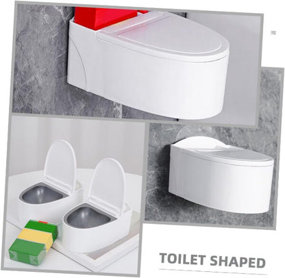 Toilet-shaped ashtray with a hand lighting a cigarette, on a gray background.