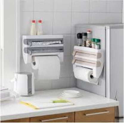 Wall-mounted 4-in-1 kitchen roll dispenser in the White color option, shown holding aluminum foil, plastic cling film, a paper towel roll, and spices on the top shelf.