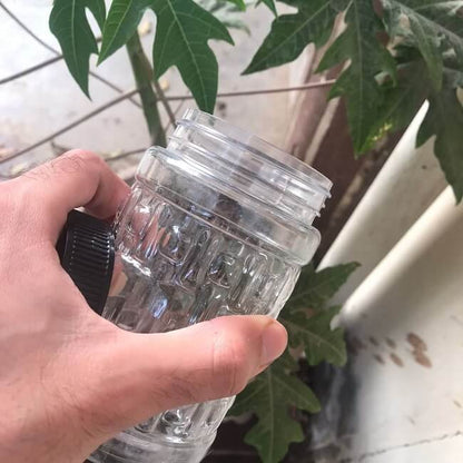 Plastic storage jar held by hand showing its size