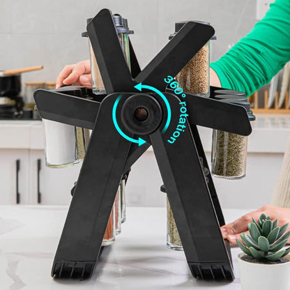Close-up of an 18-jar stainless steel rotating spice rack organizer designed like a Ferris Wheel, showing the small glass jars filled with various colorful spices and herbs on a kitchen counter.