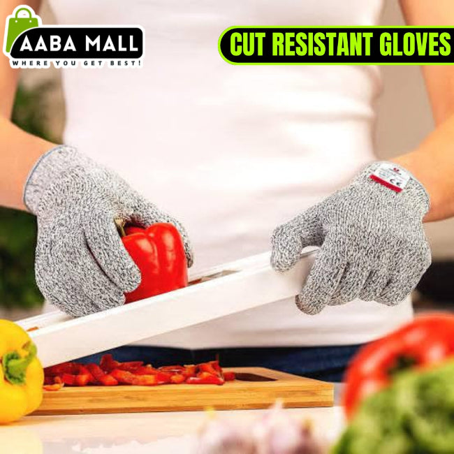 Close-up of a hand wearing a grey Level 5 cut resistant safety glove, securely holding a large onion while the other hand uses a sharp chef's knife for slicing on a cutting board.