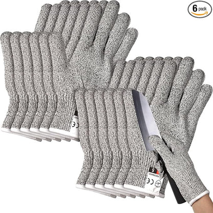 Close-up of a hand wearing a grey Level 5 cut resistant safety glove, securely holding a large onion while the other hand uses a sharp chef's knife for slicing on a cutting board.