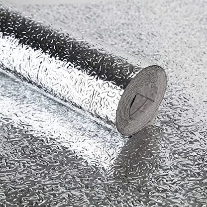 Self-adhesive aluminum foil sticker roll showing textured surface and adhesive backing