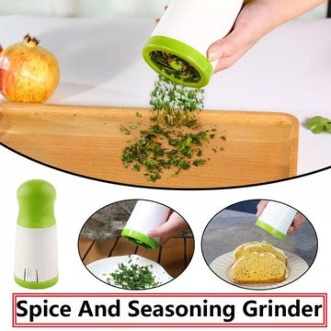 Handheld stainless steel herb mill grinder and spice chopper, shown with dry oregano inside, illustrating the sharp internal cutting mechanism and brushed steel finish.