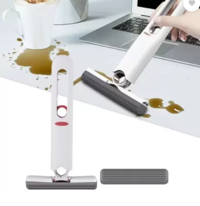 Mini portable self-squeeze mop with a white absorbent sponge head, shown using the folding mechanism to wring out water over a sink.